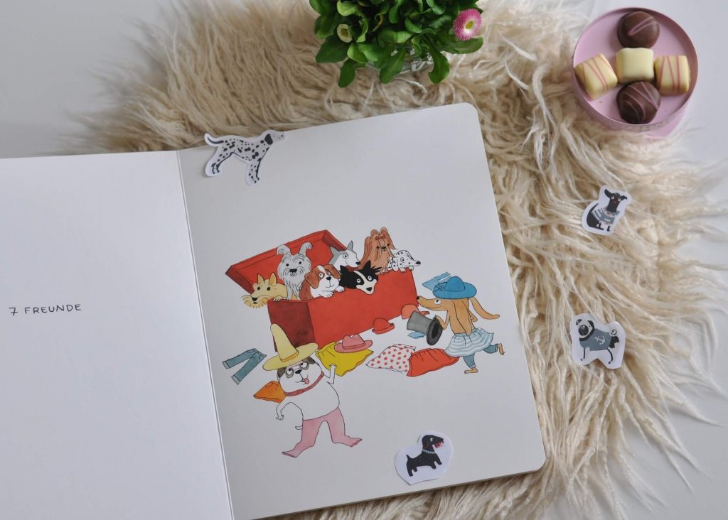 Dieser Comic mit Dorotheé Monfreids Hundebande hat nicht nur ein überraschendes Ende - kleine Kinder lernen damit spielerisch die Zahlen bis 10 sowie diverse Kleidungsstücke kennen. #pappbilderbuch #kinderbuch #lesen #comic #hund #zahlen #zählen